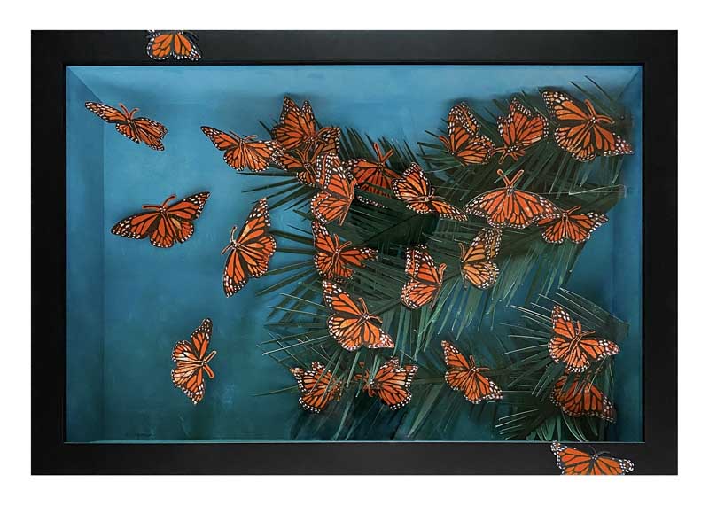 A framed artwork shows a group of orange monarch butterflies with black and white markings flying over green leaves against a blue background. Some butterflies appear to be resting on the edge of the frame.