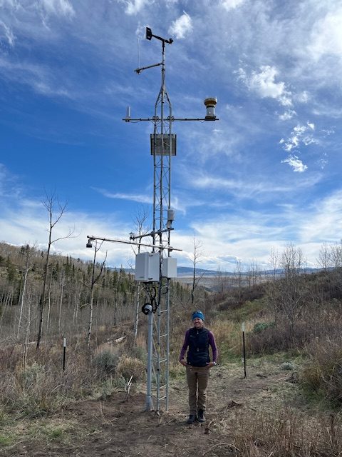 Photo of a YBASIN Station and a person standing in front of it.